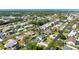 Aerial view of a charming two-story home in a residential neighborhood with the ocean visible in the distance at 915 Citrus Rd, Venice, FL 34293