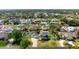 A neighborhood aerial view features the home with a spacious yard surrounded by mature trees at 915 Citrus Rd, Venice, FL 34293