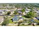An aerial shot highlights the home nestled in a quiet neighborhood with mature landscaping at 915 Citrus Rd, Venice, FL 34293