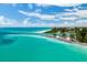 Scenic view of a turquoise beach and shoreline with blue skies and distant boats at 915 Citrus Rd, Venice, FL 34293