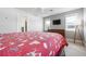 A serene bedroom showcasing wood-look flooring, a ceiling fan, and a comfortable bed with a patterned comforter at 915 Citrus Rd, Venice, FL 34293