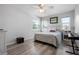 Well-lit bedroom with hardwood floors, a comfortable bed, and a side table with lamp at 915 Citrus Rd, Venice, FL 34293