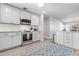 Modern kitchen with stainless steel appliances, tile backsplash, white cabinets, and ample counter space at 915 Citrus Rd, Venice, FL 34293