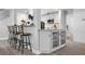 Kitchen bar with white cabinets and a view of the stainless steel appliances at 915 Citrus Rd, Venice, FL 34293