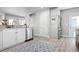 Bright kitchen with stainless steel appliances and white cabinets and a patterned rug at 915 Citrus Rd, Venice, FL 34293