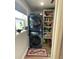 Efficient laundry room with stacked washer/dryer and shelving for storage at 915 Citrus Rd, Venice, FL 34293