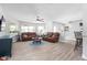 Comfortable living room with a ceiling fan, lots of natural light, wood floors, and breakfast bar nearby at 915 Citrus Rd, Venice, FL 34293