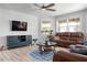 Comfortable living room featuring hardwood floors, lots of natural light, and plenty of seating at 915 Citrus Rd, Venice, FL 34293