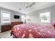 Bedroom with a ceiling fan, a dresser and windows providing natural light at 915 Citrus Rd, Venice, FL 34293