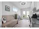 Bright office with a futon, desk and exterior door leading to a balcony at 915 Citrus Rd, Venice, FL 34293
