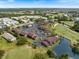Aerial view of property highlighting landscaping, community pool, and nearby golf course at 925 Capri Isles Blvd # 4, Venice, FL 34292