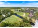 Aerial view of community showcasing landscaping, water features, and golf course at 925 Capri Isles Blvd # 4, Venice, FL 34292