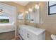 Bathroom with dual sinks and linen storage shown from bedroom; modern finishes and fixtures at 925 Capri Isles Blvd # 4, Venice, FL 34292