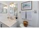 Elegant bathroom with white vanity, updated fixtures, and stylish decorative accents at 925 Capri Isles Blvd # 4, Venice, FL 34292