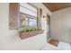 Charming condo entrance featuring a window flower box, pineapple decor, and clean, neutral exterior at 925 Capri Isles Blvd # 4, Venice, FL 34292