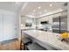 Bright kitchen with a marble countertop island, modern stainless-steel appliances, and a clean, white aesthetic at 925 Capri Isles Blvd # 4, Venice, FL 34292