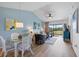 Inviting living and dining area with blue accents and access to a scenic balcony at 925 Capri Isles Blvd # 4, Venice, FL 34292