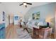 Open concept living area features blue walls, neutral furniture, and bright lighting at 925 Capri Isles Blvd # 4, Venice, FL 34292