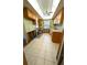 Kitchen with tile floors, light cabinets, a window, and a ceiling fan at 926 Inlet Cir, Venice, FL 34285
