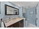 Updated bathroom boasts a modern vanity, a toilet, and a convenient, stacked washer and dryer unit at 934 Wexford Blvd # 934, Venice, FL 34293