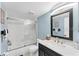 Clean bathroom featuring a shower/tub combination with a glass door and vanity with a dark wood cabinet at 934 Wexford Blvd # 934, Venice, FL 34293