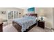 Bright bedroom features large window with plantation shutters, comfortable bed, and stylish wooden nightstands at 934 Wexford Blvd # 934, Venice, FL 34293