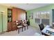 Bright bedroom with built-in wooden cabinets, natural light from the window, and neutral carpet at 934 Wexford Blvd # 934, Venice, FL 34293