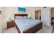 Cozy bedroom with a large bed, wooden furniture, and access to an outdoor patio for relaxation at 934 Wexford Blvd # 934, Venice, FL 34293