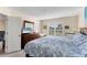 Bright bedroom features large window with plantation shutters, comfortable bed, and ample dresser storage at 934 Wexford Blvd # 934, Venice, FL 34293