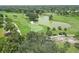 Aerial view of part of the golf course with a large body of water at 934 Wexford Blvd # 934, Venice, FL 34293