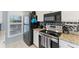 Bright kitchen featuring stainless steel appliances, granite countertops, and modern tiled backsplash at 934 Wexford Blvd # 934, Venice, FL 34293