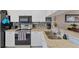 Bright kitchen featuring stainless steel appliances, white cabinets, granite countertops, and tiled backsplash at 934 Wexford Blvd # 934, Venice, FL 34293