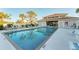Community pool with a sunny pool deck, palm trees and well-maintained landscaping at 934 Wexford Blvd # 934, Venice, FL 34293