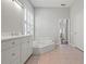 Bright bathroom featuring a soaking tub and double vanity at 1028 Grouse Way, Venice, FL 34285