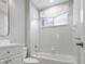 All-white bathroom features a shower/tub combo and a bright window at 1028 Grouse Way, Venice, FL 34285