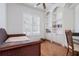 Bedroom with hard wood floors featuring built-in shelving and a large window at 1028 Grouse Way, Venice, FL 34285