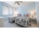 A bright bedroom with blue walls featuring two beds and a ceiling fan at 1028 Grouse Way, Venice, FL 34285