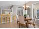 Cozy breakfast nook with a round table, seating, and views of the kitchen area at 1028 Grouse Way, Venice, FL 34285