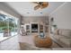 Spacious living area with neutral decor, ceiling fan, and sliding door to the pool at 1028 Grouse Way, Venice, FL 34285