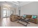 Spacious living room with tray ceilings, tile flooring, and comfortable leather sofas at 1028 Grouse Way, Venice, FL 34285