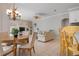 Open-concept living area with a dining table, fireplace, and comfortable seating at 1028 Grouse Way, Venice, FL 34285