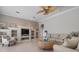 Bright living room with custom built-in shelving, neutral colors, and ceiling fan at 1028 Grouse Way, Venice, FL 34285