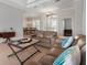 Bright living room featuring tile floors, comfortable seating, and a view into dining room at 1028 Grouse Way, Venice, FL 34285