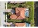 Overhead aerial perspective of the home featuring a private pool, well-manicured landscaping, and tile roof at 109 Montelluna Dr, North Venice, FL 34275