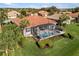 Birds-eye view of the backyard featuring screened-in lanai, swimming pool, and surrounding landscaping at 109 Montelluna Dr, North Venice, FL 34275