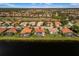 Scenic aerial view showcasing a row of residences backing onto a lake, with screened-in pools at 109 Montelluna Dr, North Venice, FL 34275