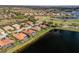 Expansive aerial view of a community with lakes, golf course, and homes with red tile roofs at 109 Montelluna Dr, North Venice, FL 34275