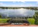 Aerial view from the roof showcasing the screened-in pool and scenic lake beyond the property at 109 Montelluna Dr, North Venice, FL 34275
