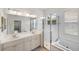 Elegant bathroom featuring double sinks, soaking tub, tiled shower, and bright natural light at 109 Montelluna Dr, North Venice, FL 34275
