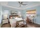 Comfortable bedroom with wood floors, ceiling fan, and lots of natural light at 109 Montelluna Dr, North Venice, FL 34275